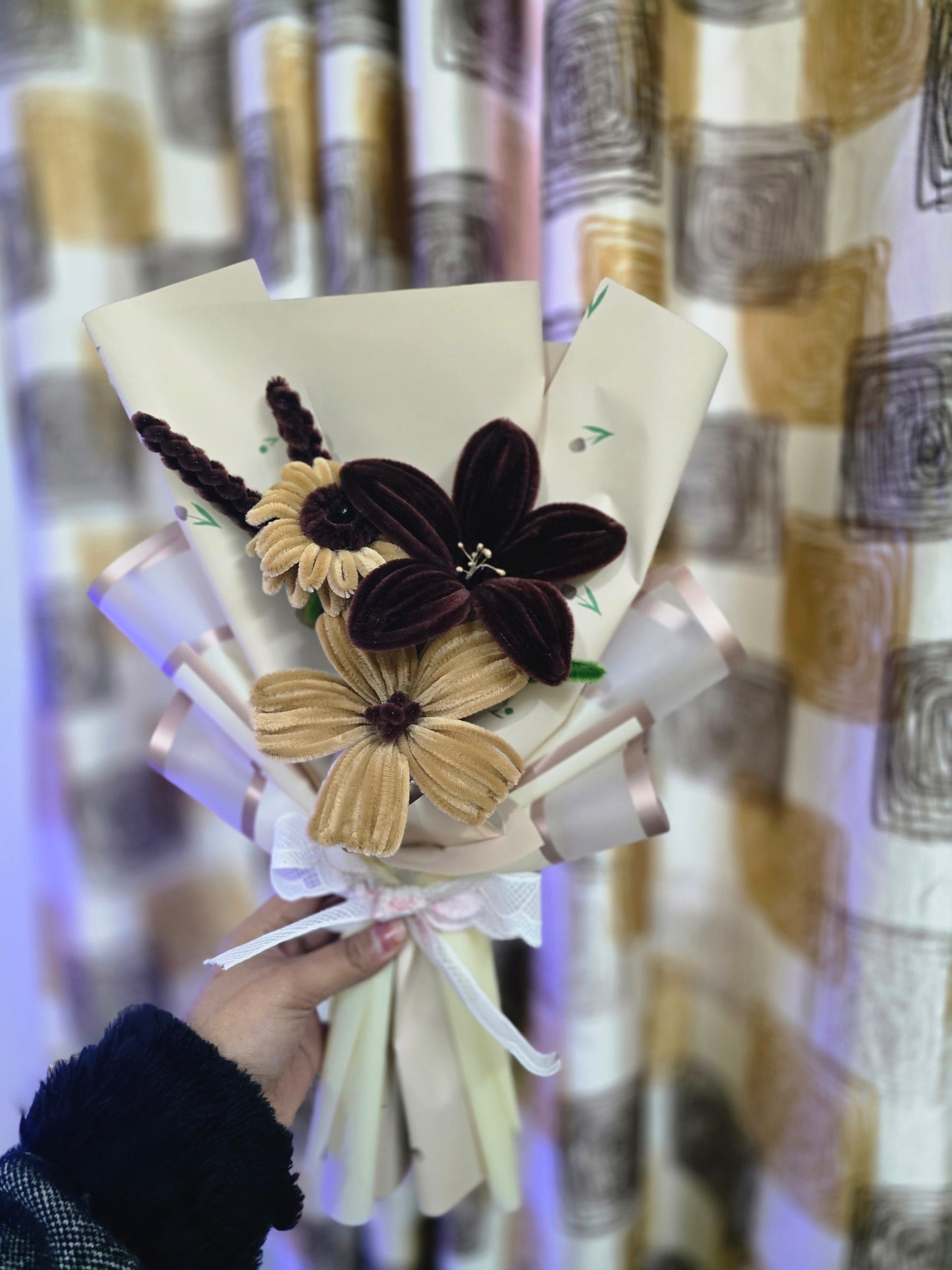 Bouquet with decorative flowers held against a patterned background